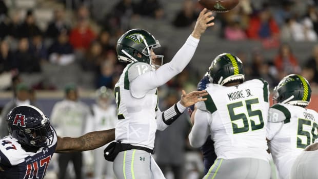 Feb 18, 2023; Houston, TX, USA; Orlando Guardian quarterback Quinten Dormady (12) throws a pass against Houston Roughnecks linebacker Chaucey Rivers (47) in the fourth quarter at TDECU Stadium. Mandatory Credit: Thomas Shea-USA TODAY Sports  